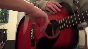 白人の少年が金曜日のギターで午後7時のギタリストに指をさす